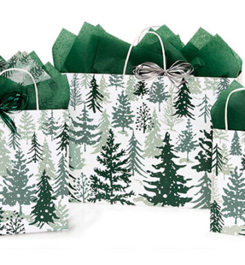 three bags of different sizes with snowy pine trees on them