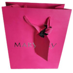 Fuchsia Mary Kay gift bag with a fuchsia luggage tag attached