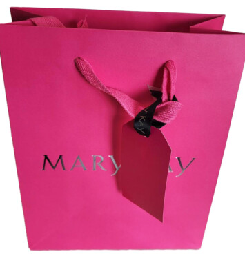 Fuchsia Mary Kay gift bag with a fuchsia luggage tag attached