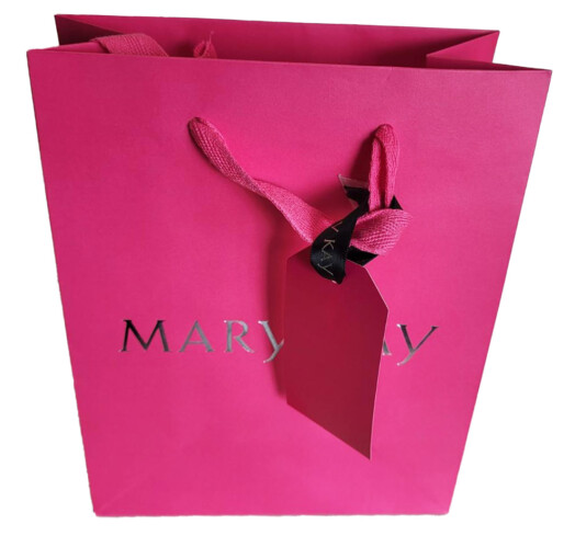 Fuchsia Mary Kay gift bag with a fuchsia luggage tag attached